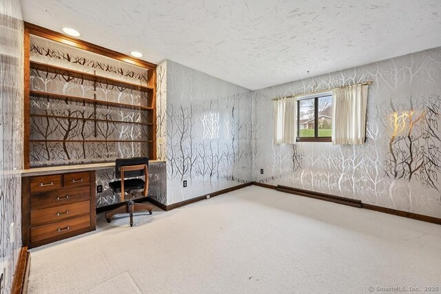 unfurnished office with baseboards, carpet flooring, a textured ceiling, and recessed lighting