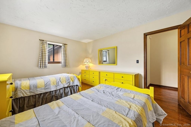 167 Arline Dr, Waterbury, CT 06705 - bedroom featuring dark wood-type flooring, a textured ceiling, and baseboards