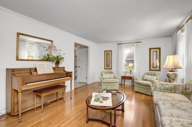 living room featuring crown molding and light wood-style floors