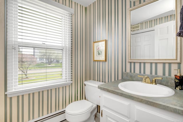 half bathroom with toilet, wallpapered walls, vanity, and a baseboard radiator