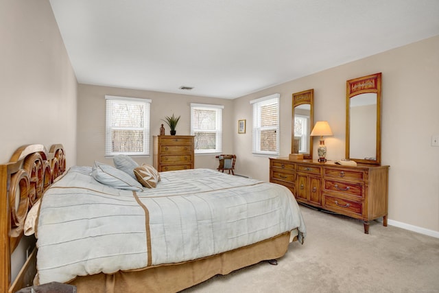 bedroom with light colored carpet, visible vents, and baseboards