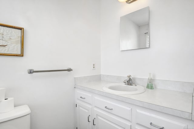 bathroom featuring toilet and vanity