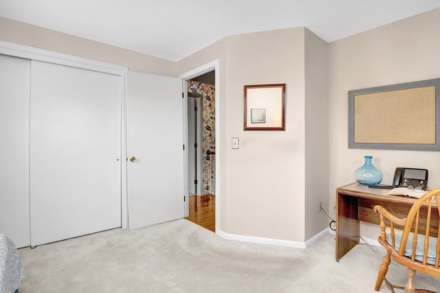 bedroom with baseboards, a closet, and carpet