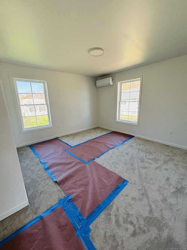 1 First St, Thompson, CT 06255 - carpeted empty room featuring an AC wall unit and baseboards