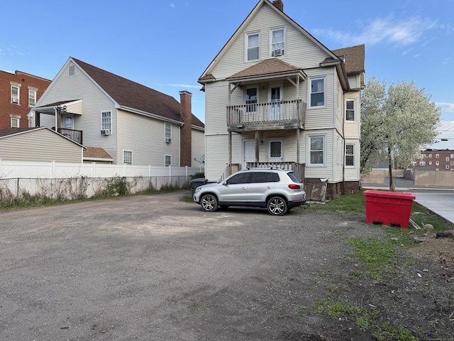 15 Eaton St, Hartford, CT 06114 - rear view of house featuring fence, a balcony, roof with shingles, and a chimney