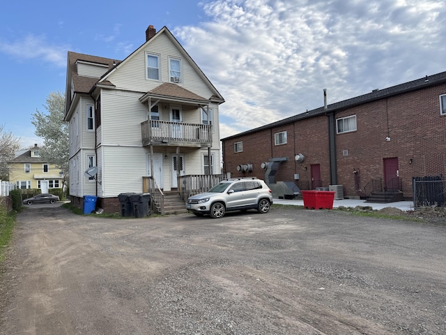 15 Eaton St, Hartford, CT 06114 - rear view of house with a chimney, central AC unit, a balcony, and a shingled roof