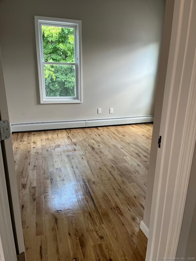 57 Erwin Pl, New Britain, CT 06051 - spare room with wood-type flooring and baseboard heating