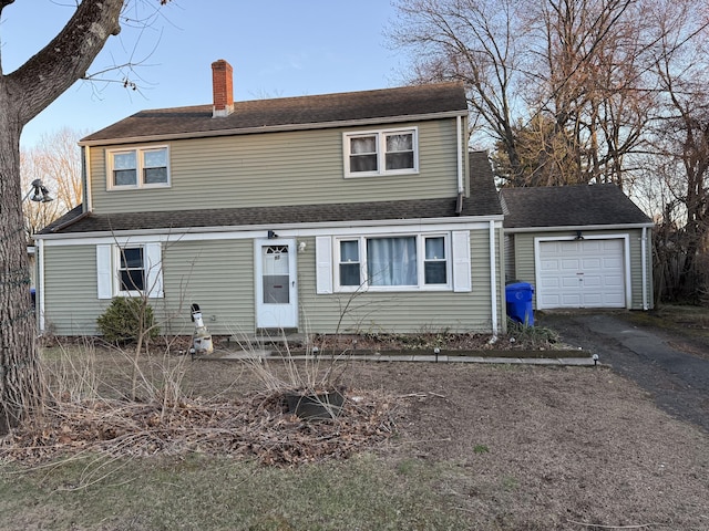 dutch colonial with roof with shingles, entry steps, aphalt driveway, and a chimney