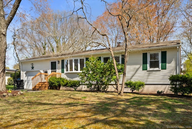 ranch-style house featuring an attached garage and a front yard