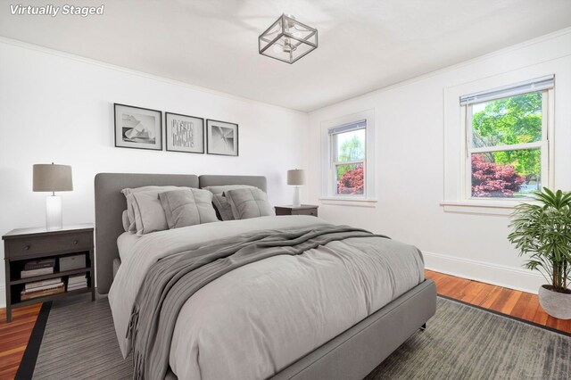 bedroom featuring baseboards and wood finished floors