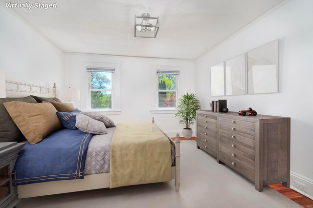 bedroom featuring crown molding and baseboards
