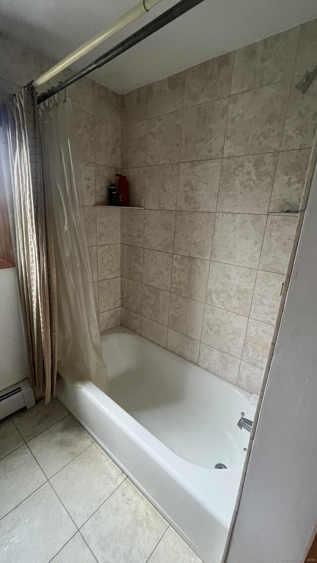 full bathroom featuring tile patterned flooring and shower / bath combo with shower curtain