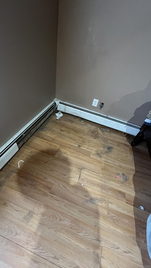 spare room featuring wood finished floors