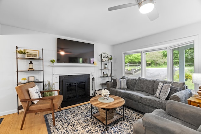52 Pine Orchard Rd, Branford, CT 06405 - living area with ceiling fan, wood finished floors, a fireplace with flush hearth, baseboards, and a baseboard heating unit