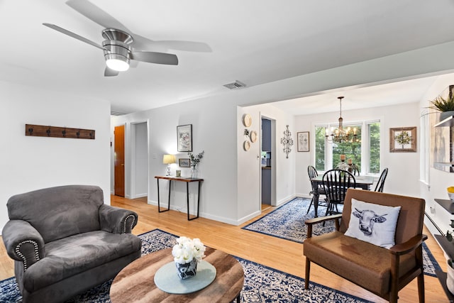52 Pine Orchard Rd, Branford, CT 06405 - living room with a chandelier, light wood-style floors, baseboards, and ceiling fan