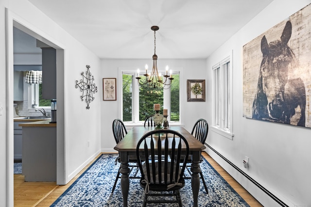 52 Pine Orchard Rd, Branford, CT 06405 - dining room featuring a baseboard radiator, a chandelier, light wood-style floors, and baseboards