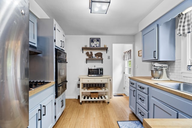 52 Pine Orchard Rd, Branford, CT 06405 - kitchen featuring stainless steel appliances, a warming drawer, backsplash, light wood-style floors, and open shelves