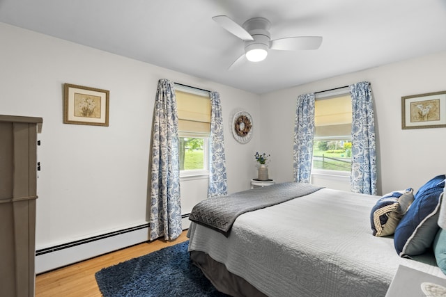 52 Pine Orchard Rd, Branford, CT 06405 - bedroom with multiple windows, wood finished floors, a baseboard radiator, and ceiling fan
