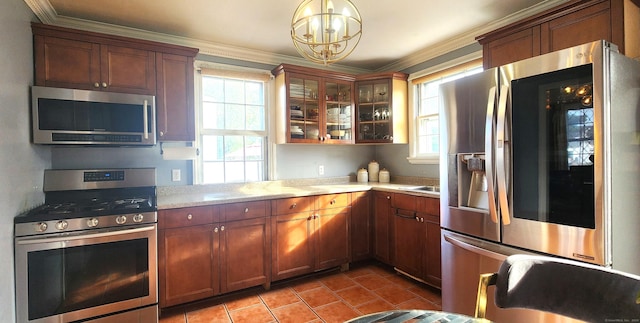97 Waterbury Ave, Stamford, CT 06902 - kitchen featuring stainless steel appliances, light countertops, a chandelier, light tile patterned flooring, and crown molding