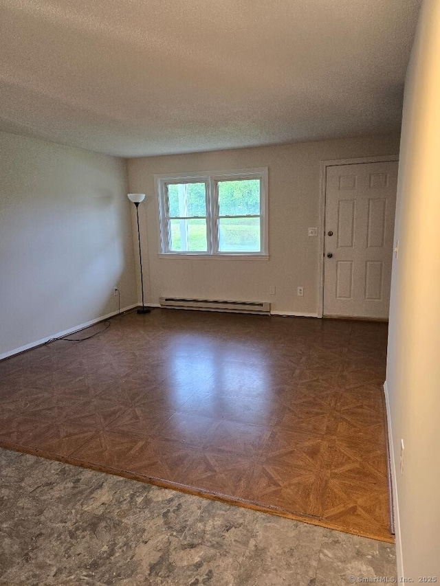 71 Arthur St Apt 2, Torrington, CT 06790 - empty room with a baseboard radiator, a textured ceiling, and baseboards