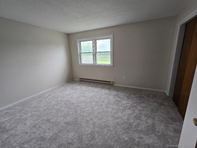 71 Arthur St Apt 2, Torrington, CT 06790 - spare room featuring a baseboard radiator, carpet, a textured ceiling, and baseboards