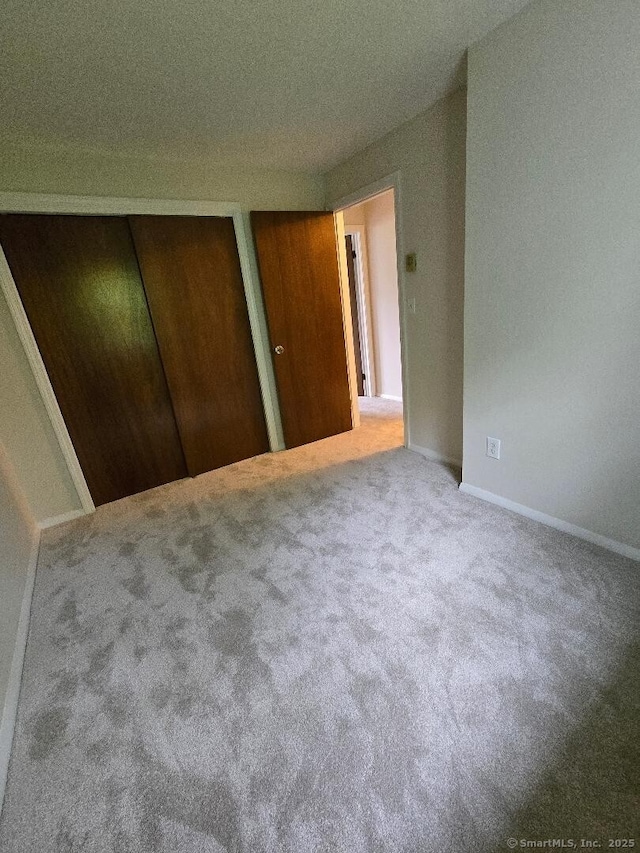 71 Arthur St Apt 2, Torrington, CT 06790 - unfurnished bedroom featuring carpet flooring, two closets, and baseboards