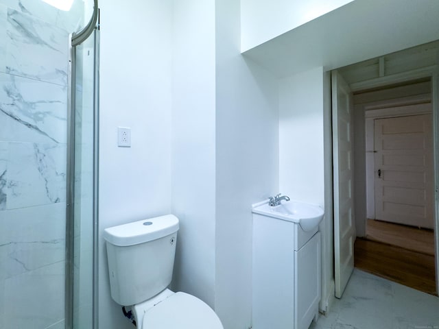 bathroom with walk in shower, marble finish floor, vanity, and toilet