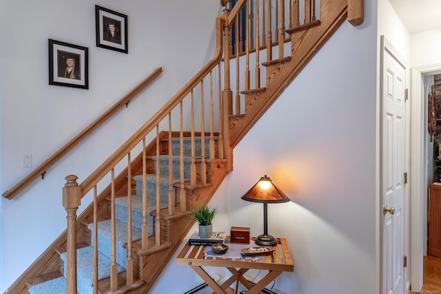 staircase featuring wood finished floors