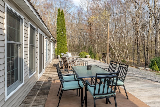 wooden deck featuring outdoor dining area