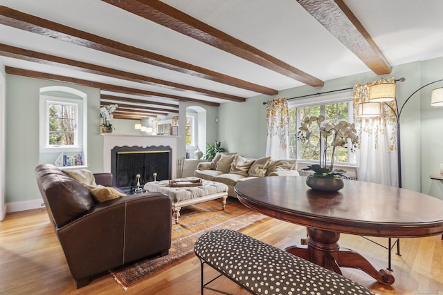 386 Bloomfield Ave, West Hartford, CT 06117 - living room with a wealth of natural light, beam ceiling, light wood finished floors, and a fireplace