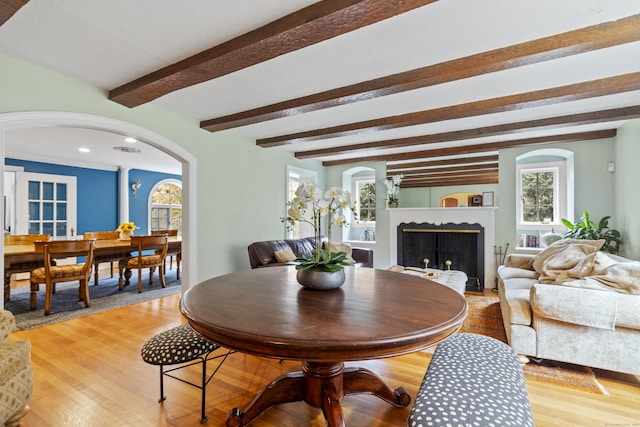 386 Bloomfield Ave, West Hartford, CT 06117 - dining area with arched walkways, light wood finished floors, a fireplace, beam ceiling, and recessed lighting