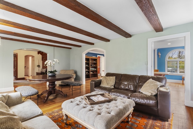 386 Bloomfield Ave, West Hartford, CT 06117 - living room with arched walkways, wood finished floors, baseboards, and beamed ceiling