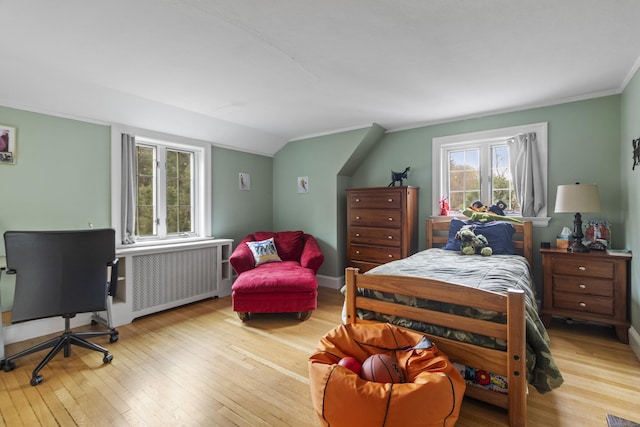 386 Bloomfield Ave, West Hartford, CT 06117 - bedroom with hardwood / wood-style flooring, vaulted ceiling, radiator heating unit, and crown molding