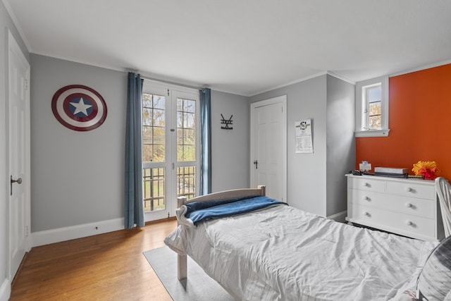 386 Bloomfield Ave, West Hartford, CT 06117 - bedroom featuring multiple windows, ornamental molding, wood finished floors, and access to outside