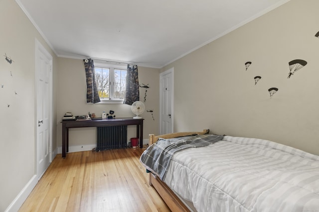 386 Bloomfield Ave, West Hartford, CT 06117 - bedroom featuring crown molding, baseboards, radiator heating unit, and hardwood / wood-style floors