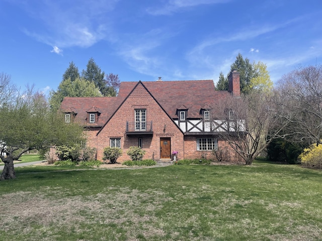 386 Bloomfield Ave, West Hartford, CT 06117 - english style home featuring a front lawn, brick siding, and a chimney