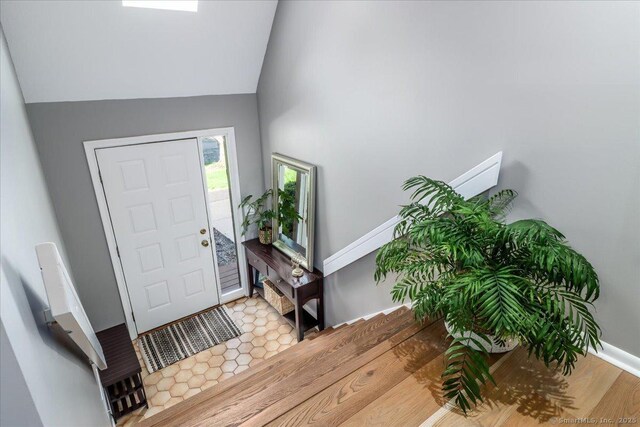 61 Wickhams Fancy Unit 61, Canton, CT 06019 - entrance foyer with vaulted ceiling, baseboards, and wood finished floors