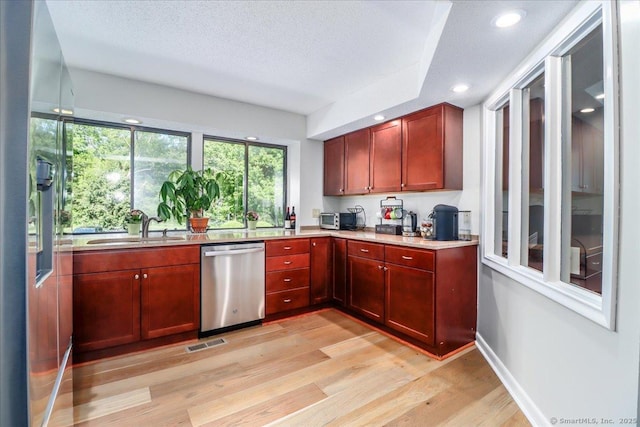 61 Wickhams Fancy Unit 61, Canton, CT 06019 - kitchen with dishwasher, light wood finished floors, reddish brown cabinets, light countertops, and a textured ceiling