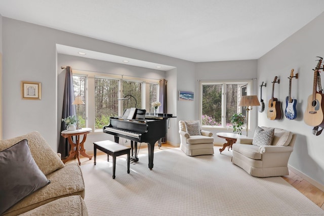 living area featuring baseboards, recessed lighting, and wood finished floors