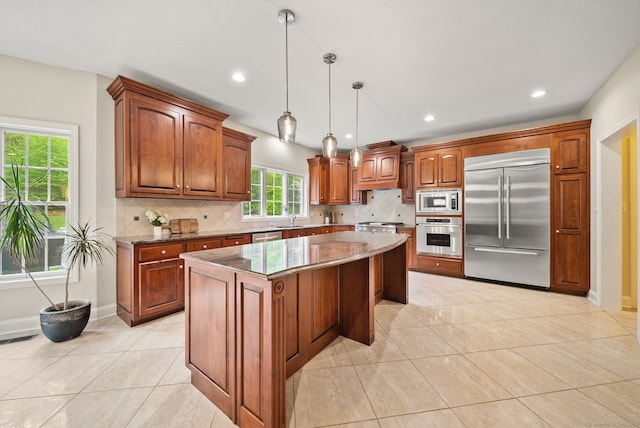 420 Winding Rdg, Southington, CT 06489 - kitchen featuring built in appliances, a sink, a kitchen island, light tile patterned floors, and tasteful backsplash