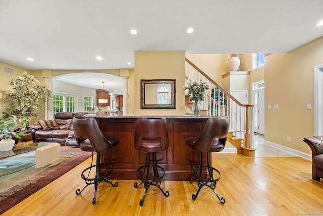 420 Winding Rdg, Southington, CT 06489 - bar area with ornate columns, arched walkways, light wood finished floors, stairway, and recessed lighting