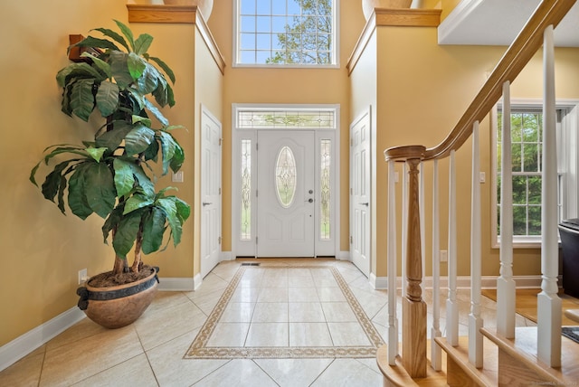 420 Winding Rdg, Southington, CT 06489 - foyer entrance with baseboards, a towering ceiling, stairway, and healthy amount of natural light