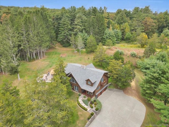 birds eye view of property with a view of trees