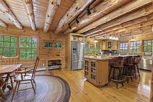 kitchen with stainless steel appliances, beam ceiling, light wood-type flooring, glass insert cabinets, and wooden ceiling