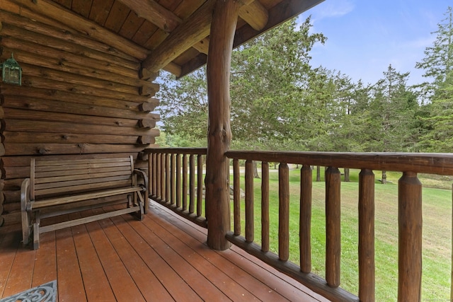 wooden deck featuring a yard