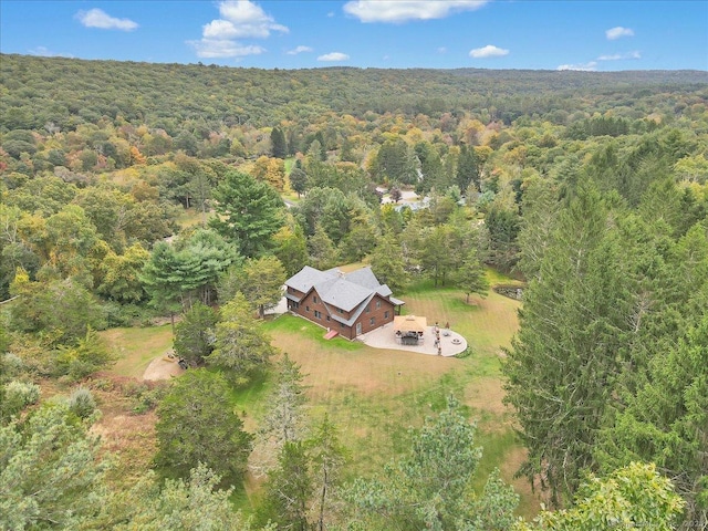 bird's eye view with a wooded view