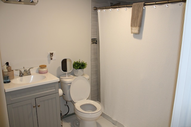 full bathroom featuring toilet, tile patterned floors, vanity, and curtained shower