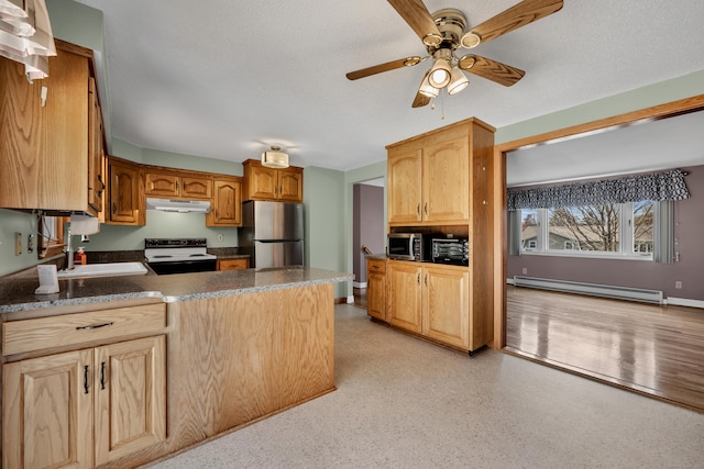 kitchen featuring a sink, a baseboard radiator, a peninsula, under cabinet range hood, and stainless steel appliances