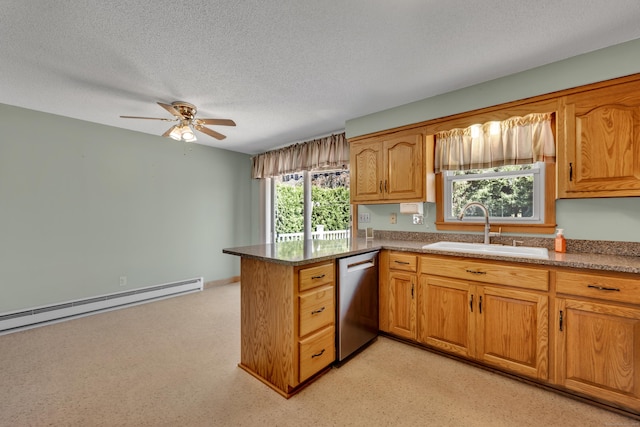 kitchen with a ceiling fan, a textured ceiling, dishwasher, a sink, and a peninsula