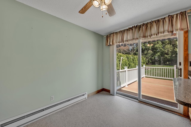 unfurnished room featuring a ceiling fan, a textured ceiling, speckled floor, baseboards, and a baseboard heating unit